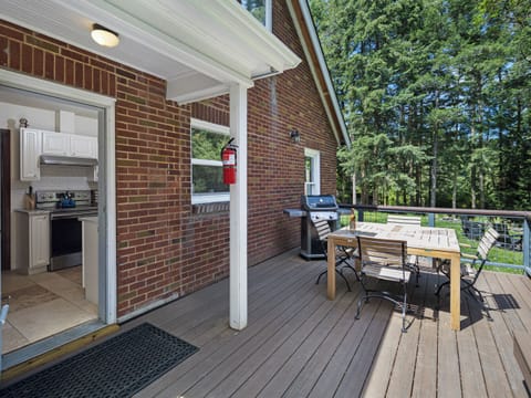 Enjoy the sunshine on the back deck with table and propane bbq.
