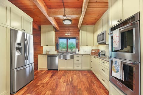 The kitchen is equipped with stainless steel appliances, including a double oven
