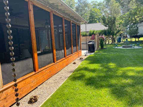 screened in porch with hot tub in background