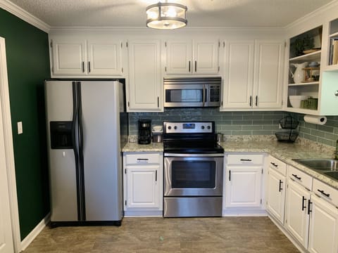 Cozy kitchen area with plenty of cooking supplies.