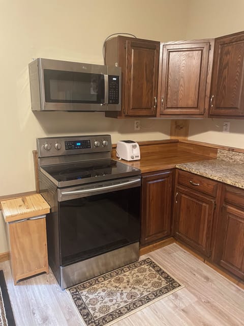 Kitchen with stove, microwave, refrigerator