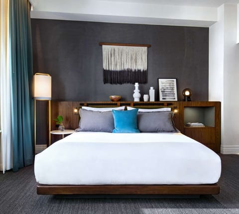 Sink into crisp linens beneath warm lamps and curated art.