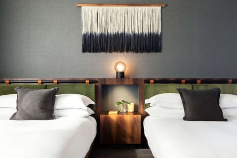 Settle in with symmetrical bedsides and calming designer textures.