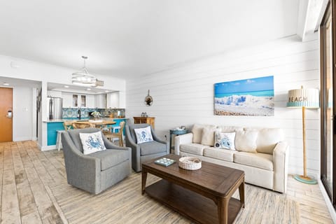 Comfortable living area with dining nearby and balcony access for pool and Gulf views.
Professionally Managed by
Breathe Easy Rentals
