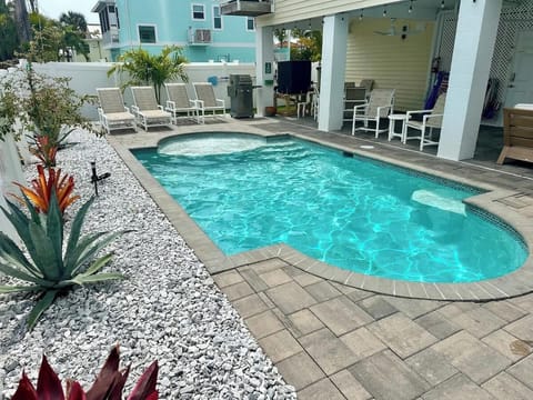 Heated Saltwater Pool with privacy fenced yard, new tropical landscaping, plenty of beach chairs, umbrellas, beach cart and cooler