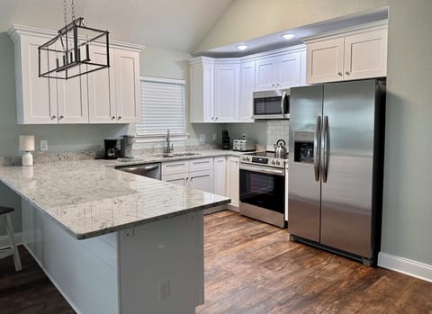 Kitchen stocked with coffee maker and Keurig.