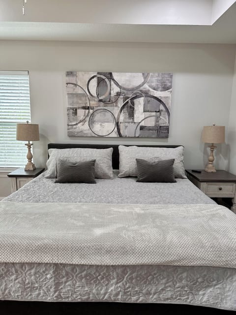 Primary bedroom with king bed, en suite bath, Smart TV, and porch access.