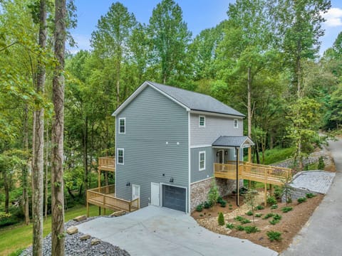 Side view of the driveway and three story house. 