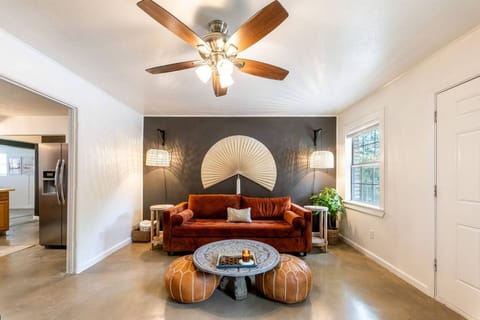 ✨Experience modern elegance and rustic charm in our curated living room. Sofa transforms to a memory foam queen bed for guests. Entertain on a 65" TV w/ Apple TV, books, games, and a waterproof speaker!  