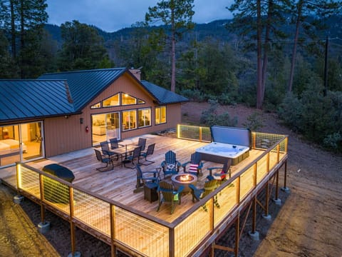 Deck with hot tub, fire pit, seating area and grill