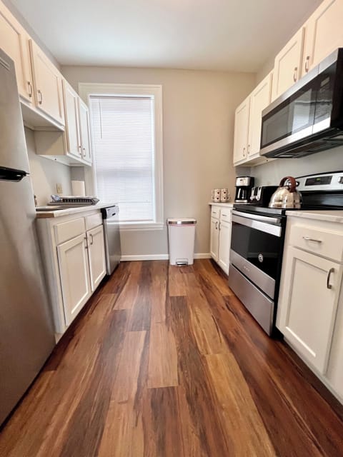 Fully stocked kitchen with all essential cookware and dinnerware.