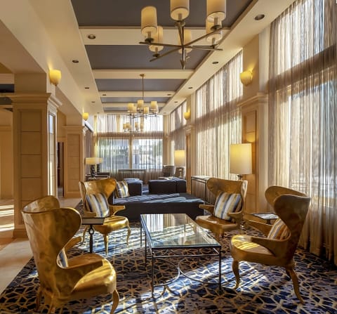 Gather for morning coffee in a sunlit, elegant lounge.
