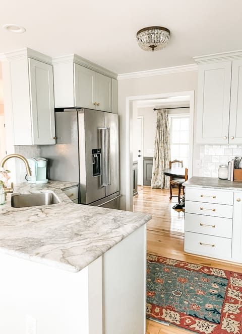 Bright kitchen with marble counters, sleek cabinets, and open flow—perfect for entertaining!