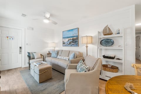 Cozy living room with coastal decor and comfortable seating.