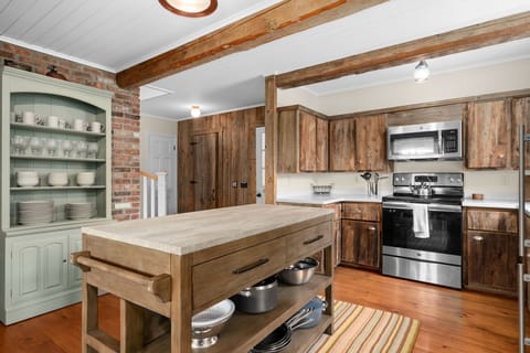 Kitchen with ample workspace and island with two stools