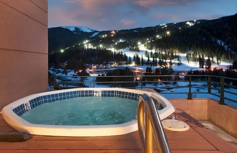 Soak under alpine skies with glowing mountain views.