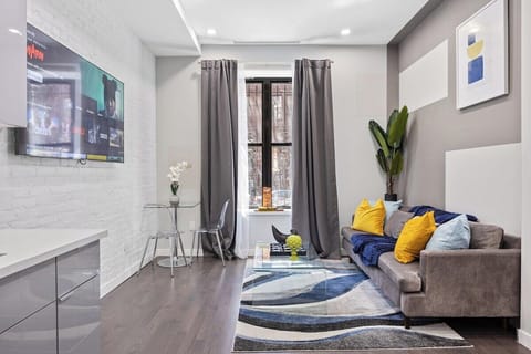 Experience seamless elegance and open-concept living in this captivating view, where the living room, dining table, and kitchen intertwine to create a space of modern comfort and effortless style.