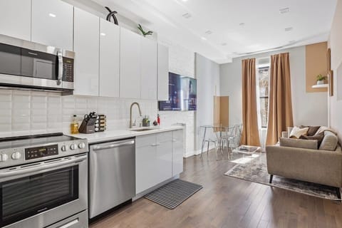 Experience seamless elegance and open-concept living in this captivating view, where the living room, dining table, and kitchen intertwine to create a space of modern comfort and effortless style.