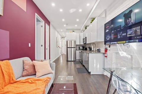 Experience seamless elegance and open-concept living in this captivating view, where the living room, dining table, and kitchen intertwine to create a space of modern comfort and effortless style.