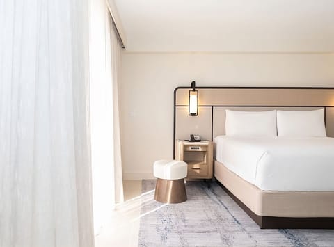 Unwind in crisp linens and soothing, sunlit calm.