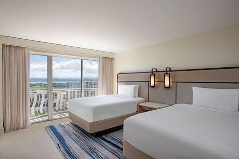 Unwind in airy comfort with skyline views beyond the balcony.