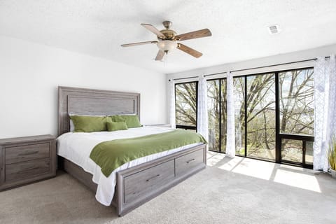 Your king suite hosts a wall of windows with natural views reaching to the lake.
