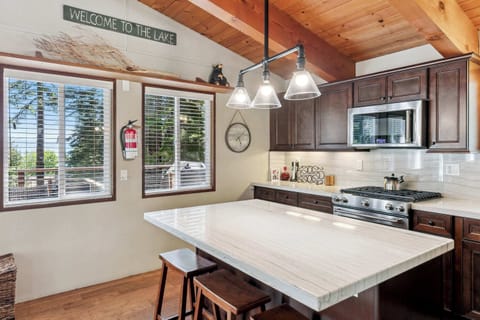 Warm and inviting kitchen with sunny windows and a roomy island, ideal for family meals and easy vacation cooking.