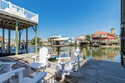 Relax in your waterfront chairs overlooking the peaceful canal, where colorful beach houses create a picturesque backdrop for your perfect getaway.