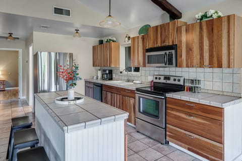 The kitchen is fully stocked with stainless steel appliances