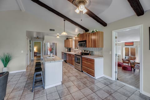To the left of the kitchen is the hallway to the first two bedrooms, and to the right is the entrance to the third bedroom