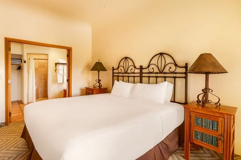 Relax into plush bedding with warm lamps and calming desert tones