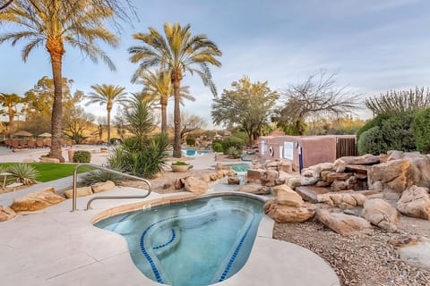 Unwind in the bubbling hot tub surrounded by natural stone.