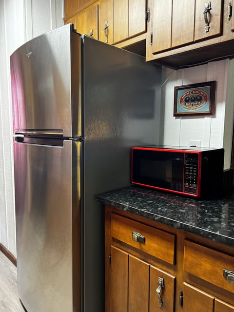 Kitchen has microwave, dishwasher, refrigerator, and stove