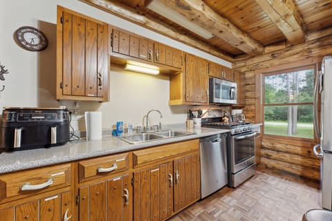 The lodge kitchen has a microwave, dishwasher, stove, fridge, Keurig