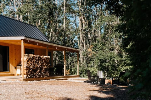 Backyard with fire ring and hot tub off the large covered porch.
