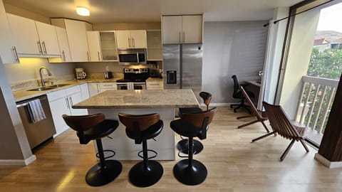 Kitchen. Acacia chairs at window. Office work place.
