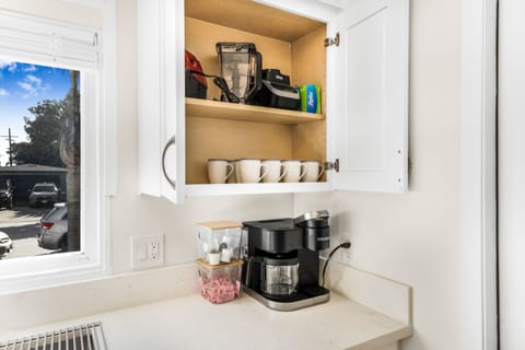 Keurig Coffee Machine, pods and sweetener provided.