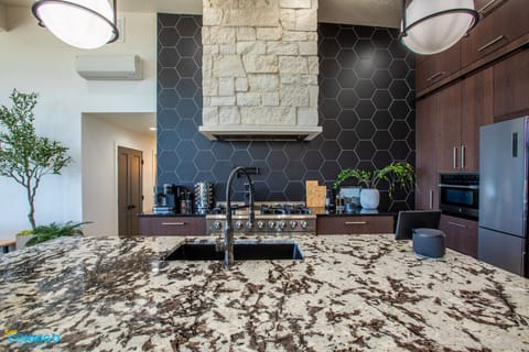 Enjoy a fully equipped kitchen with high-end finishes and bar seating