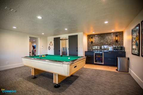 Stylish game room with pool table, bar, and après-ski vibes.