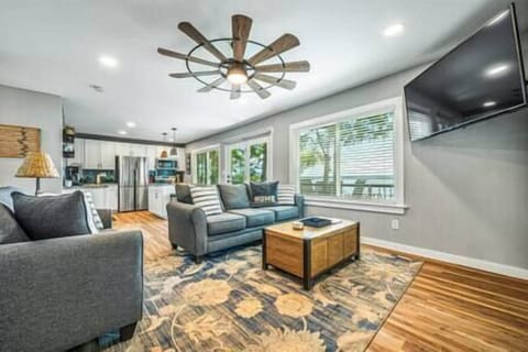 Open living room with big TV and views.