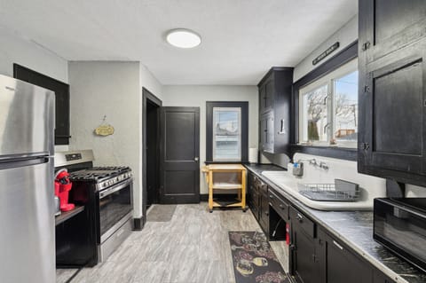 Fully stocked kitchen including dishes and cookware.