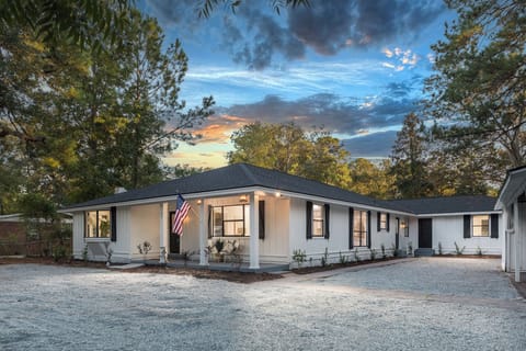 Apartment door seen on right side of home and apartment is on back side of home.