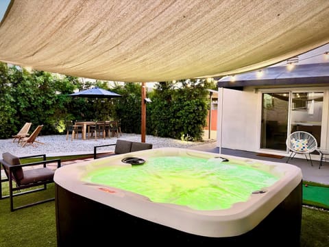 Gated large yard with hot tub, outdoor seating, propane grill, putting golf.