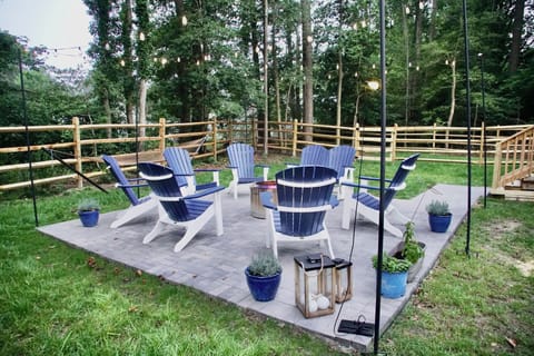 Outdoor patio with plenty of seating and firepit with bistro lights.