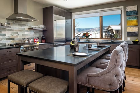 The spacious kitchen island with a view of Emerald Mountain and over the top sunsets.