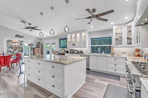 A granite topped eating counter with barstool seating is great for meal prep as well as serving.