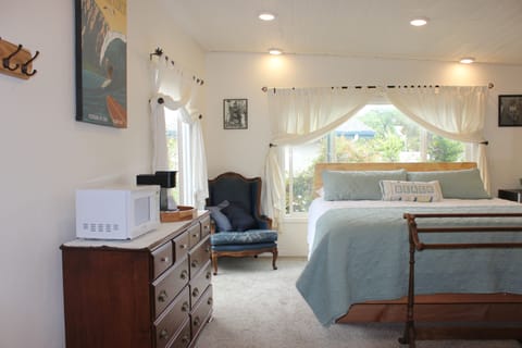 Bright and airy bedroom includes coffee maker, microwave and refrigerator