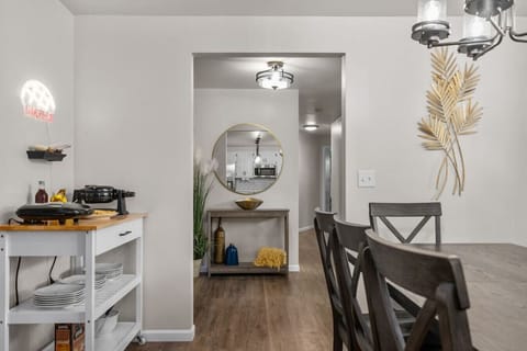 View from the dining area into the entry way and hallway that leads to the laundry room, a bathroom and the master bedroom.