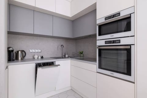 Kitchenette with oven and refrigerator. 