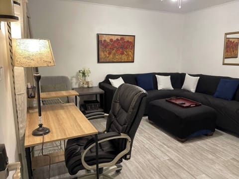 Living room with large sectional and smart TV and desk area